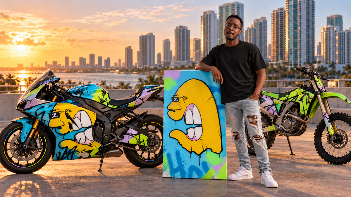 Purnell the Painter beside a colorful sport motorcycle, dirt bike, and yellow character painting at golden hour